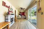 Discover this charming lakeside retreat featuring a cozy living area with a stone fireplace and a bunk bed setup, perfect for accommodating guests.