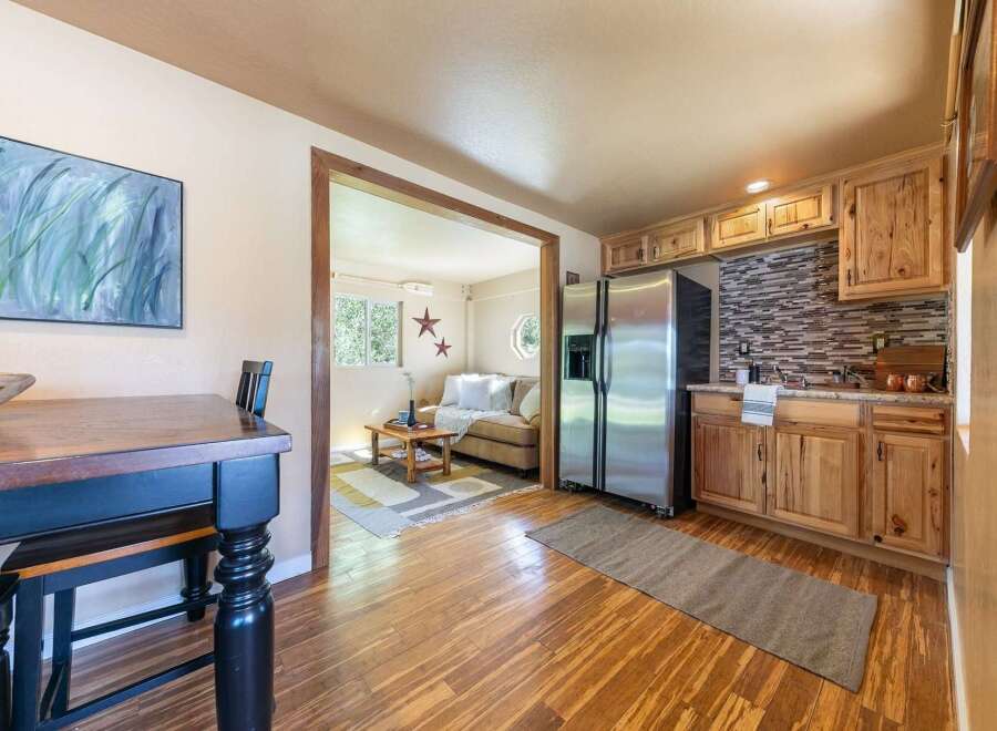 Discover this charming home featuring a spacious living area and a well-equipped kitchen with modern appliances and ample cabinet space.