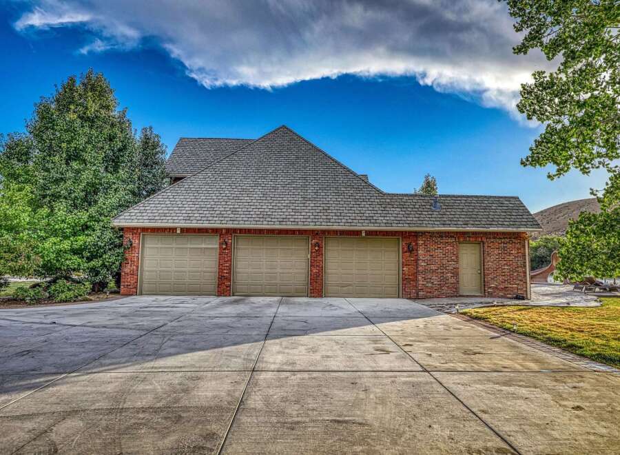 This stunning property boasts a spacious three-car garage, perfect for car enthusiasts or those needing extra storage.