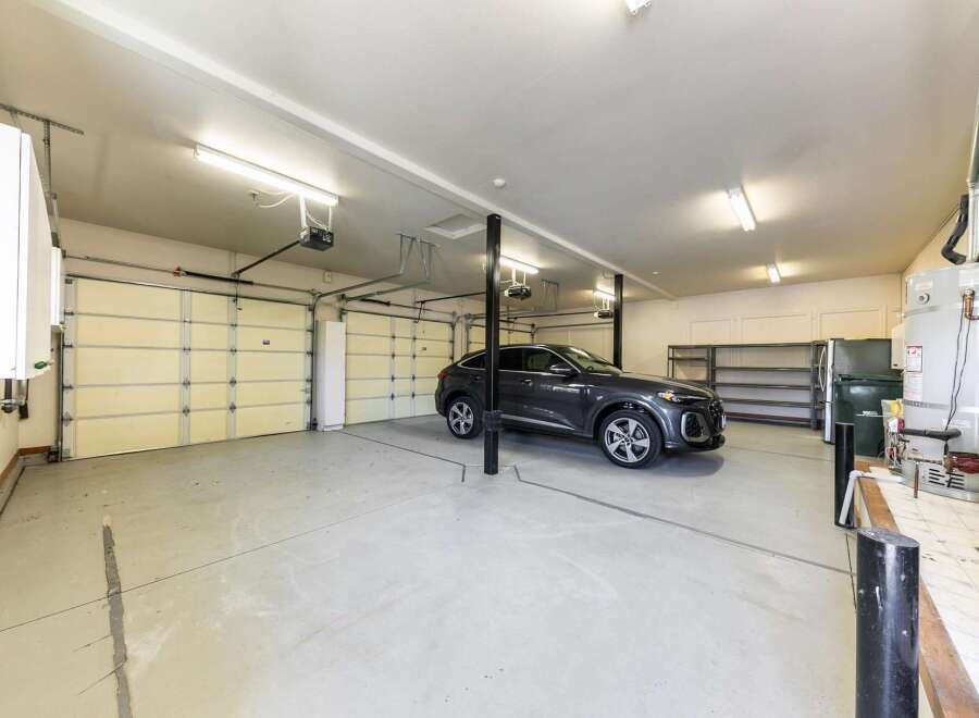 This spacious garage offers ample parking with its multiple overhead doors, perfect for accommodating several vehicles.