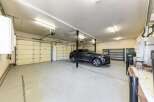 This spacious garage offers ample parking with its multiple overhead doors, perfect for accommodating several vehicles.