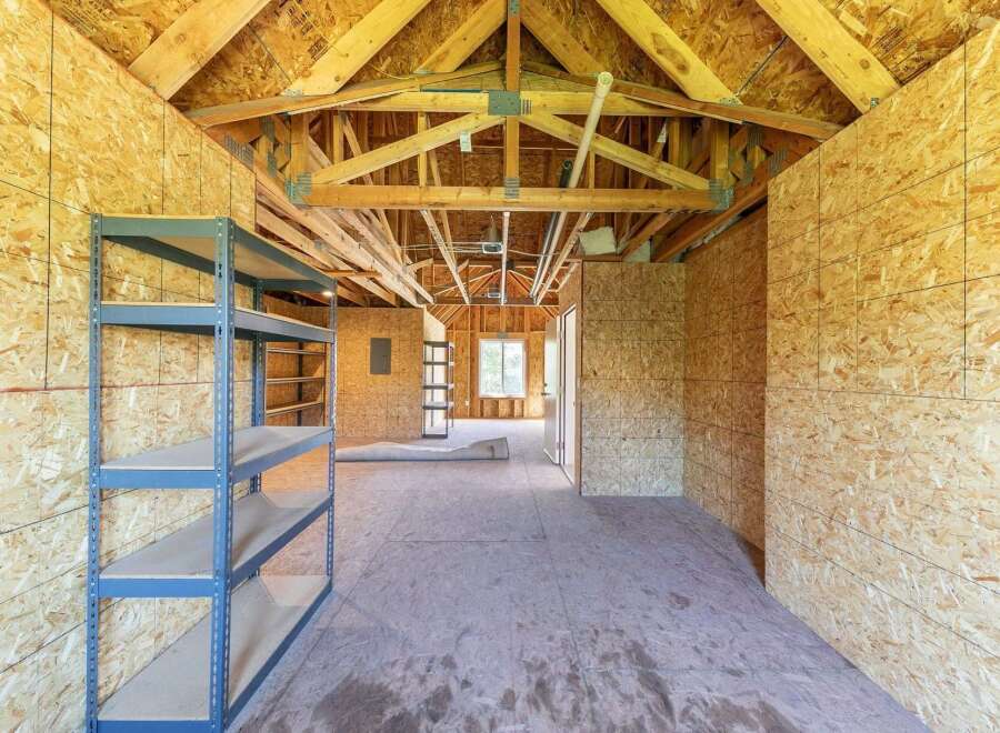 Discover the potential of this unfinished space, perfect for a workshop, storage, or custom build-out.