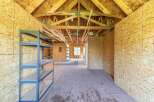 Discover the potential of this unfinished space, perfect for a workshop, storage, or custom build-out.