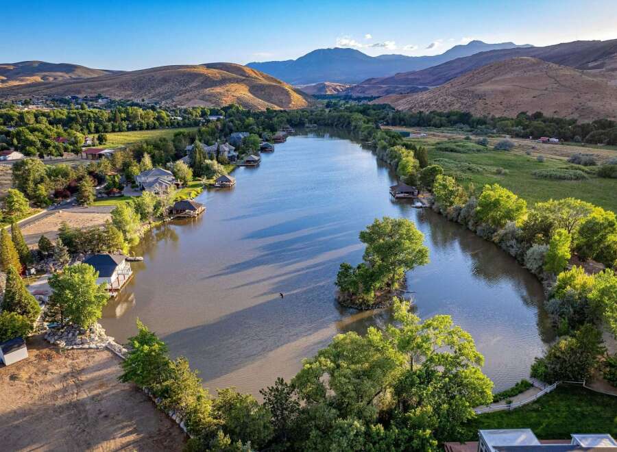 Experience luxury lakeside living with this stunning aerial view of a serene lakefront property.