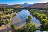 Experience luxury lakeside living with this stunning aerial view of a serene lakefront property.
