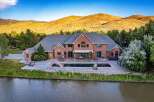 Experience luxury living with this stunning brick estate, featuring a sprawling backyard oasis complete with a large swimming pool, waterslide, and hot tub.