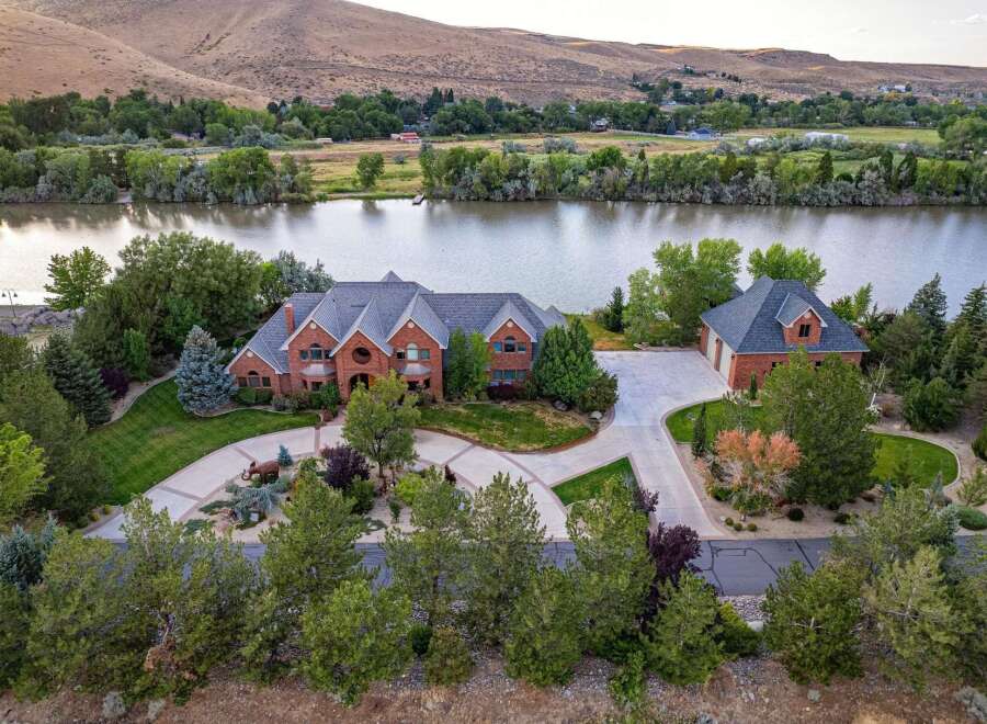 Experience luxury living with this stunning brick estate situated on a serene waterfront.