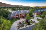 Experience luxury living with this stunning brick estate nestled beside a serene river, offering breathtaking views and ample space.