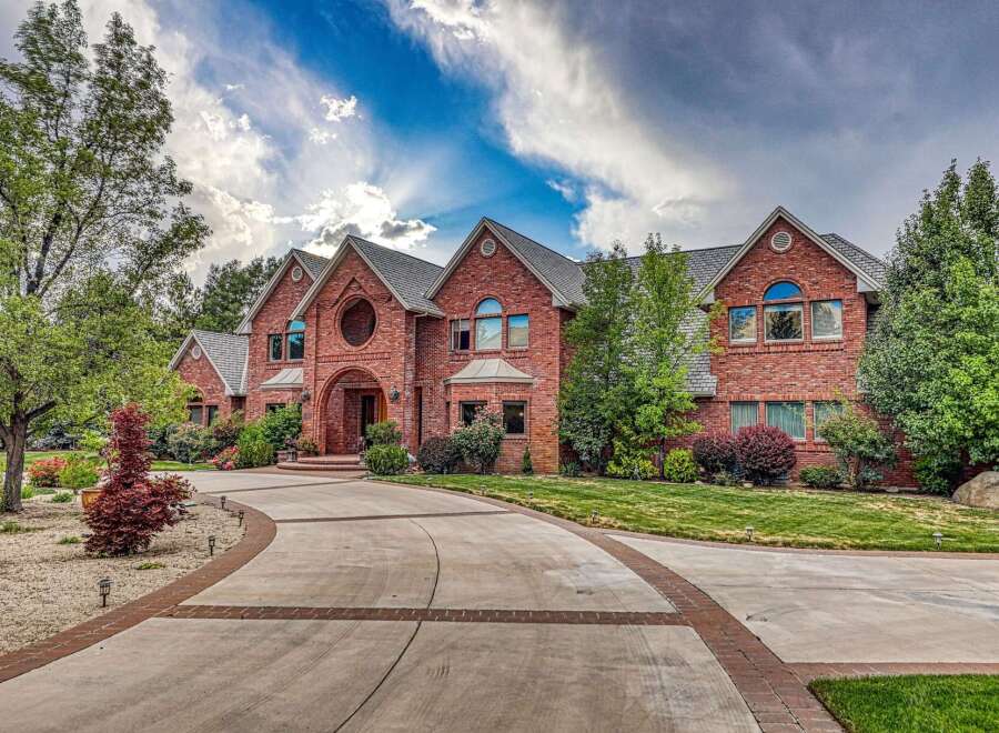 Discover this stunning brick estate, featuring a grand arched entryway and a circular window accent.