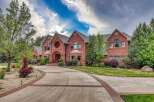 Discover this stunning brick estate, featuring a grand arched entryway and a circular window accent.