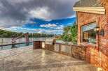 Experience luxury outdoor living with this stunning backyard oasis, featuring a sparkling pool with a water slide and a fully equipped outdoor kitchen.