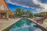 Experience luxury outdoor living with this stunning backyard oasis, featuring a sparkling swimming pool and a relaxing hot tub.