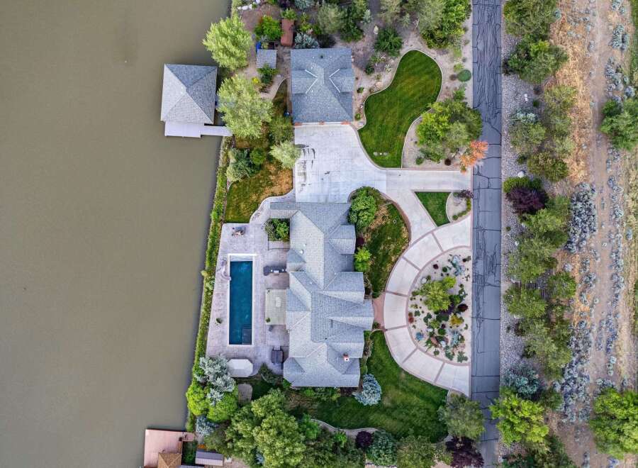 Experience luxury waterfront living in this stunning estate featuring a private dock and boathouse on the serene lake.