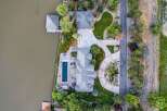 Experience luxury waterfront living in this stunning estate featuring a private dock and boathouse on the serene lake.