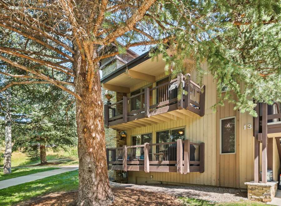Nestled amidst mature trees, this charming property offers multiple levels of outdoor living space, perfect for enjoying the serene surroundings.