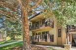Nestled amidst mature trees, this charming property offers multiple levels of outdoor living space, perfect for enjoying the serene surroundings.