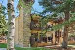 Experience mountain living in this charming property featuring a striking stone-clad chimney and multiple balconies perfect for enjoying the fresh air.