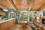 Experience rustic charm in this inviting dining area, featuring a cozy wooden table and chairs perfect for intimate meals.