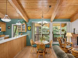 Experience rustic charm in this inviting dining area, featuring a cozy wooden table and chairs perfect for intimate meals.