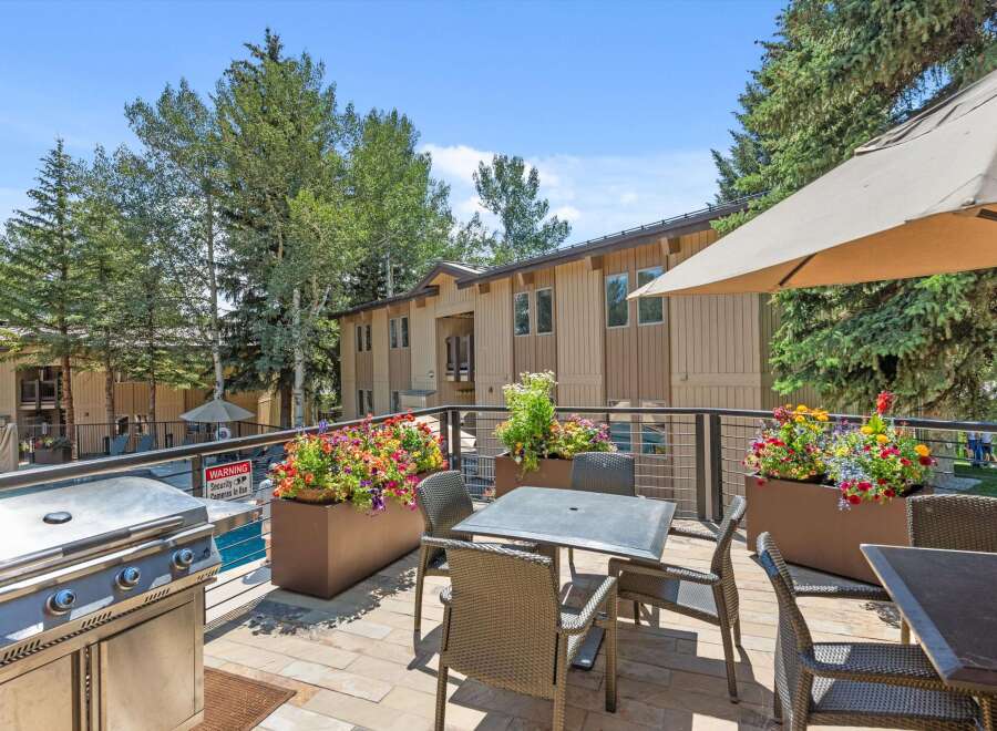 Enjoy outdoor living at its finest on this spacious balcony, complete with a stainless steel grill and comfortable seating.