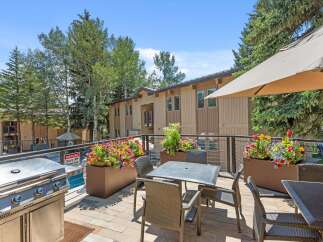 Enjoy outdoor living at its finest on this spacious balcony, complete with a stainless steel grill and comfortable seating.