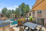 Enjoy outdoor living at its finest with this spacious balcony featuring a built-in grill and comfortable seating area.