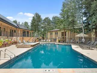 Enjoy a refreshing dip in this stunning outdoor swimming pool, complete with a relaxing hot tub.