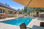 Enjoy a refreshing dip in this stunning swimming pool, complete with a relaxing hot tub and ample lounge seating.