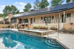 Experience luxury outdoor living with this stunning property featuring a sparkling swimming pool and a relaxing hot tub.