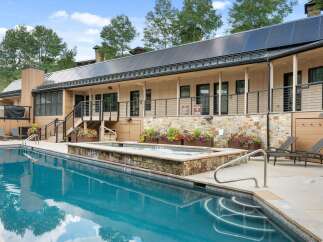 Experience luxury outdoor living with this stunning property featuring a sparkling swimming pool and a relaxing hot tub.
