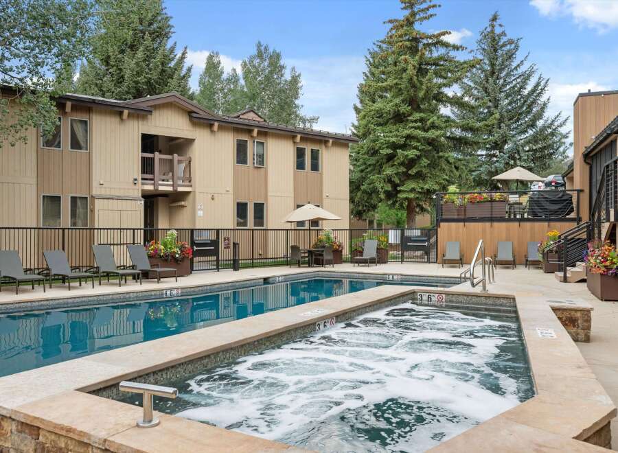Enjoy a refreshing dip in the sparkling blue pool or relax in the bubbling hot tub at this inviting property.
