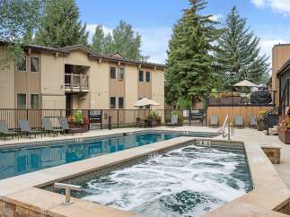 Enjoy a refreshing dip in the sparkling blue pool or relax in the bubbling hot tub at this inviting property.