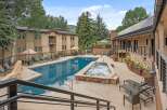 Enjoy a refreshing dip in the sparkling blue swimming pool or relax in the bubbling hot tub, surrounded by lush trees and mountain views.