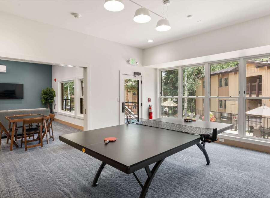 Enjoy indoor recreation with a game of ping pong in this spacious common area.