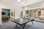 Enjoy indoor recreation with a game of ping pong in this spacious common area.