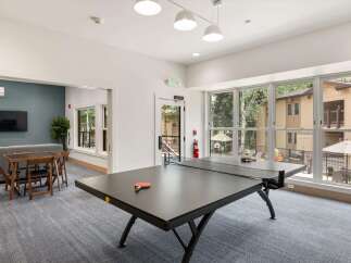 Enjoy indoor recreation with a game of ping pong in this spacious common area.