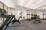 Elevate your fitness routine in this well-equipped home gym, featuring a Peloton bike and a NordicTrack treadmill for cardio enthusiasts.