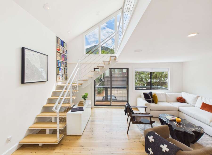 Experience modern living in this stunning home featuring a dramatic open-concept living area with soaring vaulted ceilings and expansive windows that flood the space with natural light.