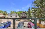 Experience mountain living with this stunning property featuring a spacious balcony overlooking a private parking area with multiple vehicles.