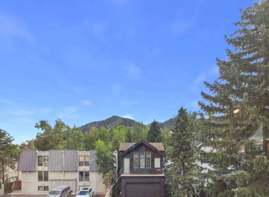 Experience mountain living in this charming property, nestled amongst lush trees with a stunning mountain backdrop.