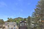 Experience mountain living in this charming property, nestled amongst lush trees with a stunning mountain backdrop.