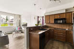 Discover this inviting open-concept living space, seamlessly blending a modern kitchen with a cozy living area.
