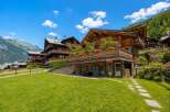 Experience alpine living in this stunning wooden chalet, nestled amidst breathtaking mountain scenery.