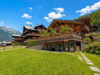 Experience alpine living in this stunning wooden chalet, nestled amidst breathtaking mountain scenery.