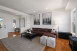 This spacious living room features a luxurious brown leather sectional sofa, perfect for relaxing and entertaining.