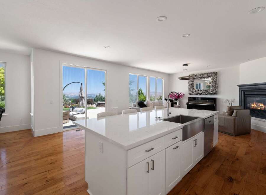 Experience luxury living in this stunning open-concept home, featuring a gourmet kitchen with a large island and sleek countertops.