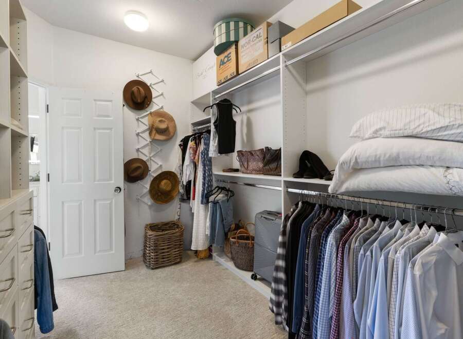 Discover ample storage in this spacious walk-in closet, featuring custom shelving and organized hanging racks for all your clothing and accessories.
