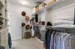 Discover ample storage in this spacious walk-in closet, featuring custom shelving and organized hanging racks for all your clothing and accessories.