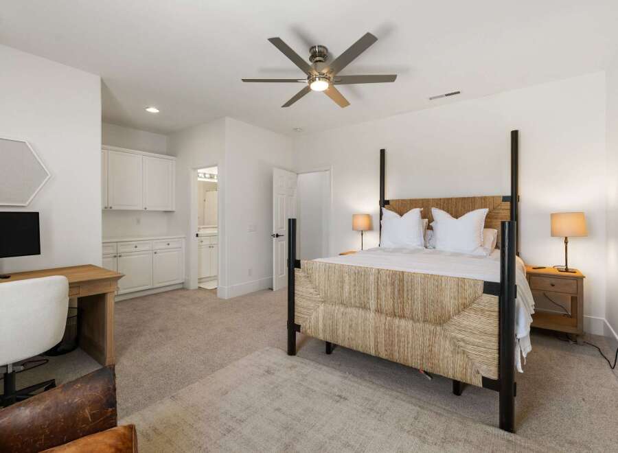 This spacious bedroom features a comfortable king-size bed with a unique woven headboard, perfect for a restful night's sleep.