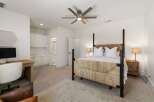This spacious bedroom features a comfortable king-size bed with a unique woven headboard, perfect for a restful night's sleep.